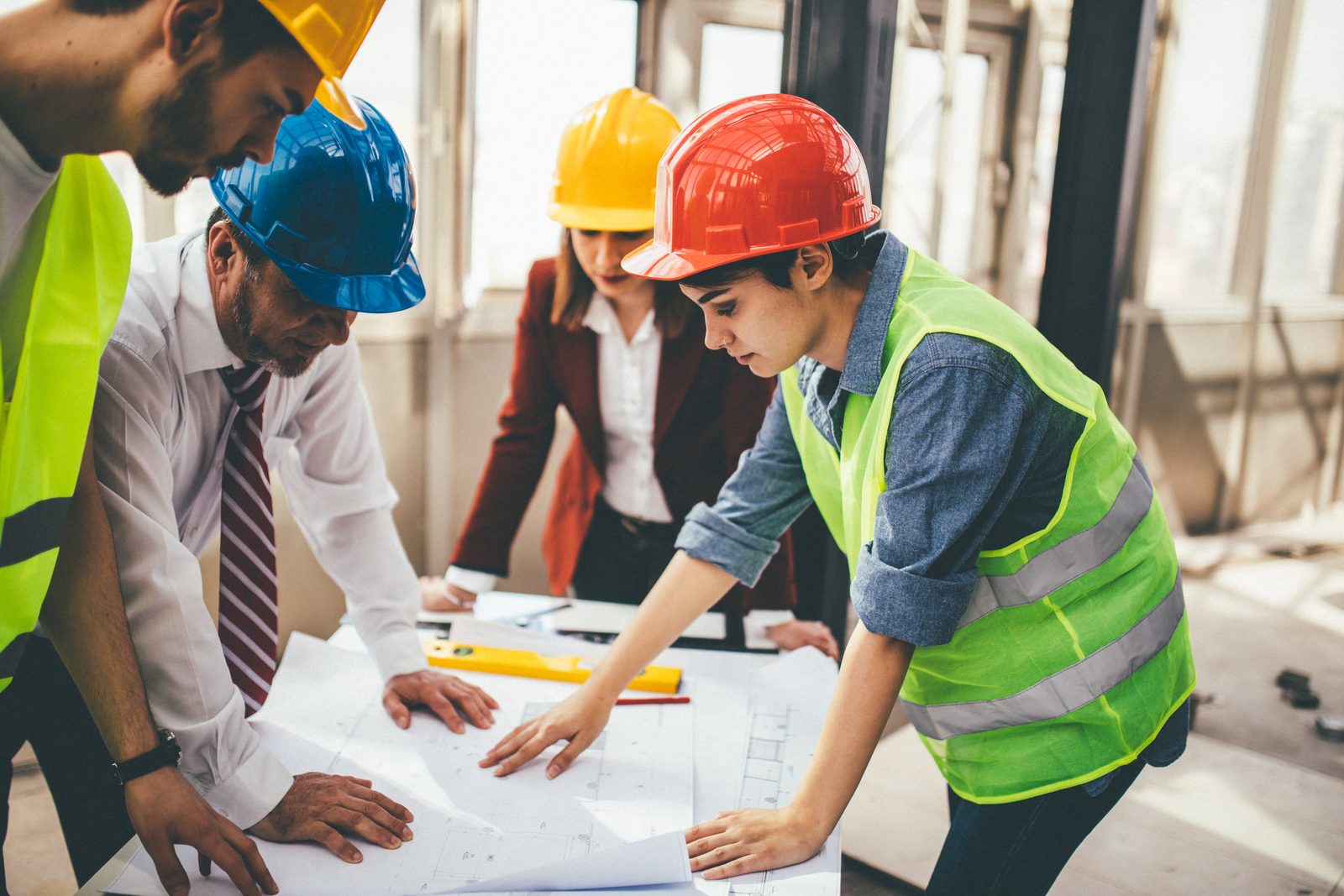 Project team reviewing construction blueprints together